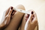 Image of a woman holding a pregnancy test