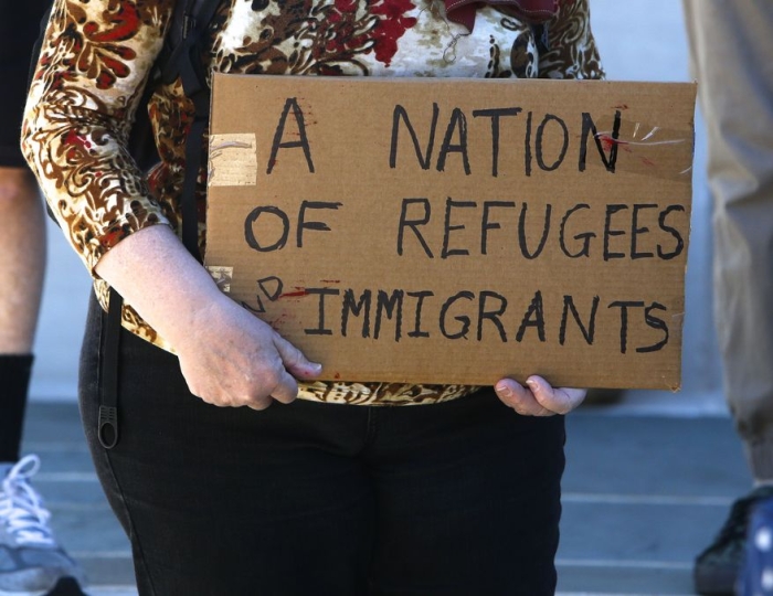 Women with pro-refugee sign